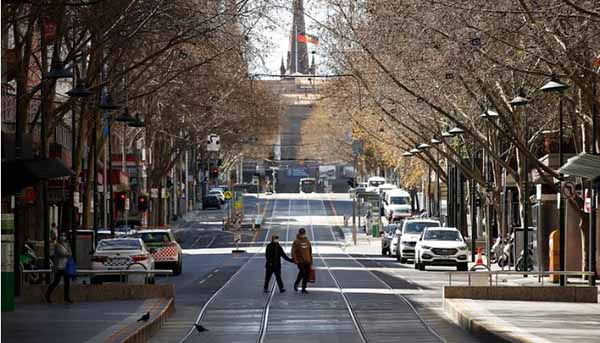 A woman is seen exercising along a quiet Bourke Street