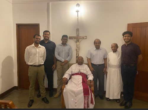 Presenting the book to Archbishop Emeritus Oswald