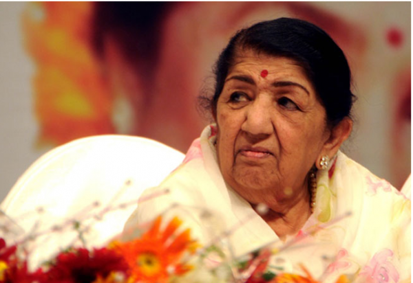 NEW DELHI, February 6: India’s legendary playback singer Lata Mangeshkar passed away in a Mumbai hospital on Sunday after a prolonged illness, including Covid complications. She was 92. Muse to some of Indian cinema’s greatest composers, recipient of the country’s highest civilian honour the Bharat Ratna, and the embodiment of Indian femininity on the movie screen for over 50 years, she breathed her last in a hospital, where she was admitted a month ago after testing Covid-positive. Born in 1929 to Marathi classical singer and theatre actor Pandit Deenanath Mangeshkar and his Gujarati wife Shevanti in Indore in Madhya Pradesh state, Mangeshkar has sung for over seven generations of female actors in India, with her voice often being described as ‘virginally pure’ and her playback for an actress symbolic of the latter having made it in Bollywood, particularly through the 1960s and 70s when the singer was at her peak. The eldest child of the family with sisters Meena, Asha, and Usha, and brother Hridaynath, all accomplished singers and musicians, Mangeshkar began her career at the age of 13 after her father’s death by singing for a Marathi film called Kiti Hasal (1942). Her move to Mumbai in 1945 was followed by small numbers in a few movies until the big breakthrough happened with “Aayega Aanewala” composed by Naushad and picturized on Madhubala in Mahal (1949). She worked with composers as disparate as Anil Biswas, Shankar Jaikishan, Naushad Ali, S.D. Burman, C. Ramchandra, Hemant Kumar, Salil Chowdhury, Khayyam, Ravi, Sajjad Hussain, Roshan, Kalyanji-Anandji, Madan Mohan, and Usha Khanna over the next several years. Mangeshkar had the unique distinction of singing for around seven different generations of female actors: Madhubala and Nimmi in the 1940s, Meena Kumari , Nargis and Nutan in the ‘50s, Waheeda Rehman, Asha Parekh and Sharmila Tagore in the ‘60s, Mumtaz, Hema Malini , Jaya Bhaduri and Zeenat Aman in the ‘70s, Sridevi and Rekha in the ‘80s, Juhi Chawla, Karisma Kapoor and Manisha Koirala in the ‘90s and Preity Zinta and Kareena Kapoor in the 2000s. Together with sister Asha, who was known for more sensuous songs compared with the older sister’s simple chastity, Lata Mangeshkar was widely notorious for her monopoly over the film music industry during those years. Legend has it that composers such as Hemant Kumar and Madan Mohan had waited for the singer to recover from her illness and sing for their films Bees Saal Baad (1962) and WohKaun Thi (1964). The songs she sang after her doctors once declared that she would sing never again, such as Kahin Deep Jale Kahin Dil in Bees Saal Baad and Naina Barse in Woh Kaun Thi are considered Mangeshkar’s milestones. For singers and musicians who had not been treated as stars in India until then, she had brought a unique status and stardom during those years, aided by the growth and popularity of the radio. Widely respected in the Indian film industry and affectionately called ‘Didi’ (elder sister) by all, Mangeshkar recorded songs in several thousand films across 36 regional Indian languages and foreign languages, primarily in Marathi, Hindi, and Bengali. She remains an enduring memory thanks to her signature white sari clad figure and her songs notching up views and streams endlessly across streaming platforms for newer generations to discover her. She has also composed music for a couple of Marathi films and produced four movies, including Gulzar’s Lekin (1991). Among her exhaustive charitable work is a hospital in her father’s name in Pune called Deenanath Mangeshkar Hospital and Research Centre. Lata Mangeshkar, who remained unmarried, is survived by a large family, including her siblings and their children and a legion of fans across the world who would today swear by the words that poet and music director Naushad had once written for the singer: “The very heart of India throbs in your voice.” And to attend her funeral. Tributes came in from Prime Minister Narendra Modi and countless number of celebrities and ordinary admirers from all over the world. India declared national mourning in her honour. She was laid to rest with military honours. Modi flew down to Mumbai to bid her farewell.