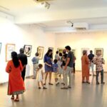 Guests at the gallery viewing the works of Beven