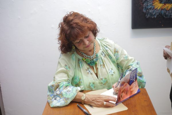 Beverley signing each book with a specific message for each reader.